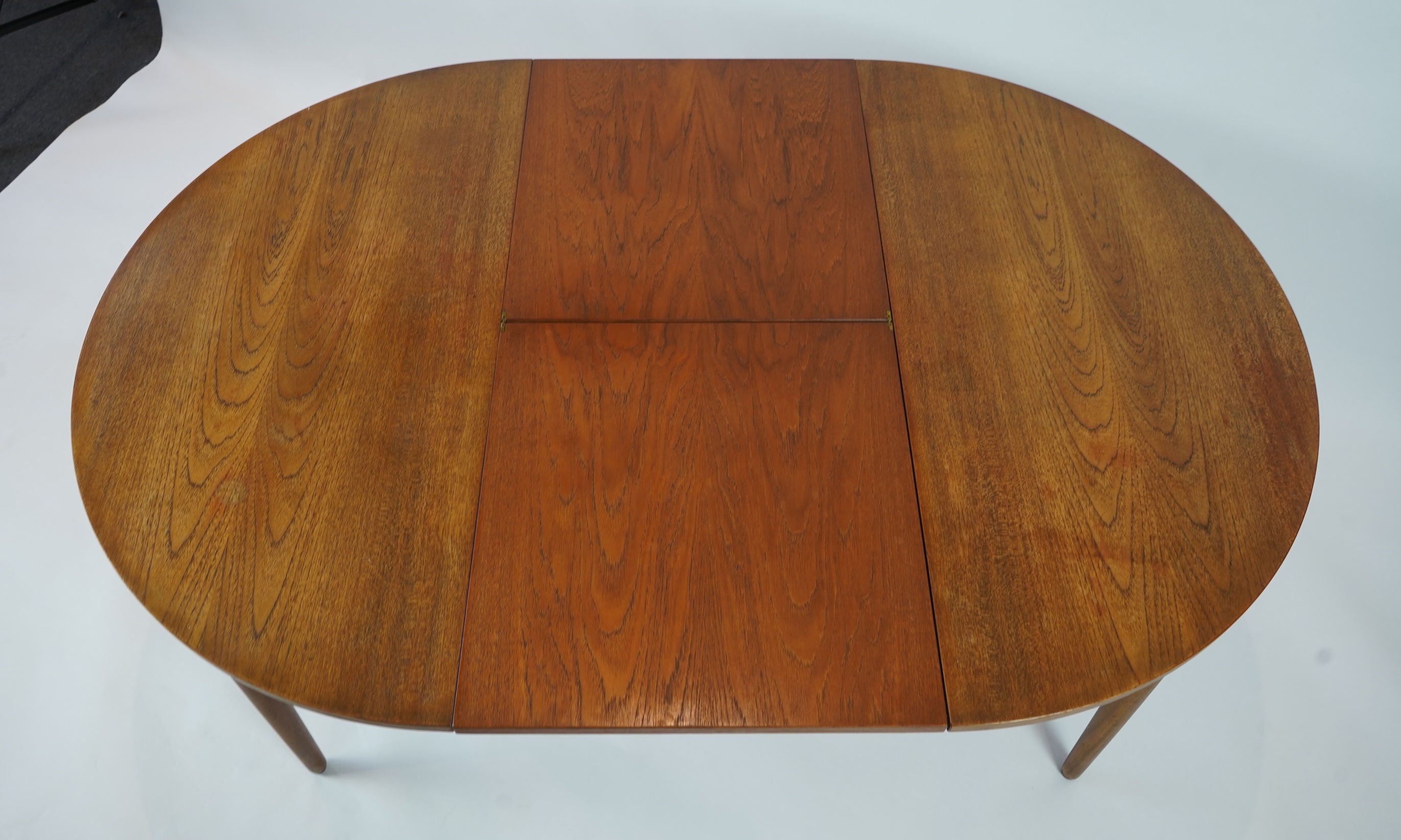 Hans Olsen (Danish, 1919–1992) for Frem Røjle: A Danish teak 'Roundette' extending dining table and four chairs